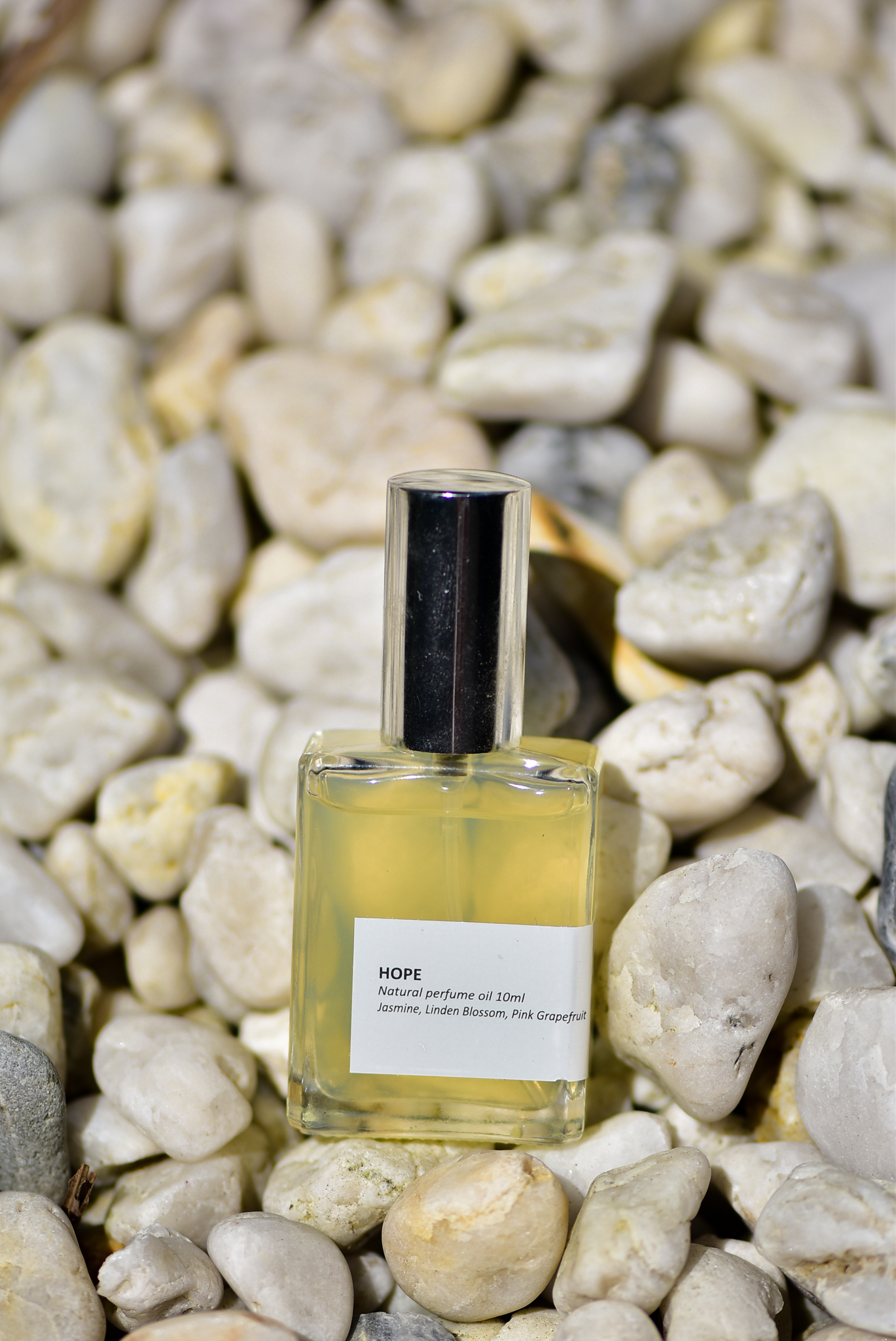 'Hope' oil perfume captured on a background of white rocks.