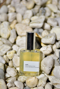 'Hope' oil perfume captured on a background of white rocks.