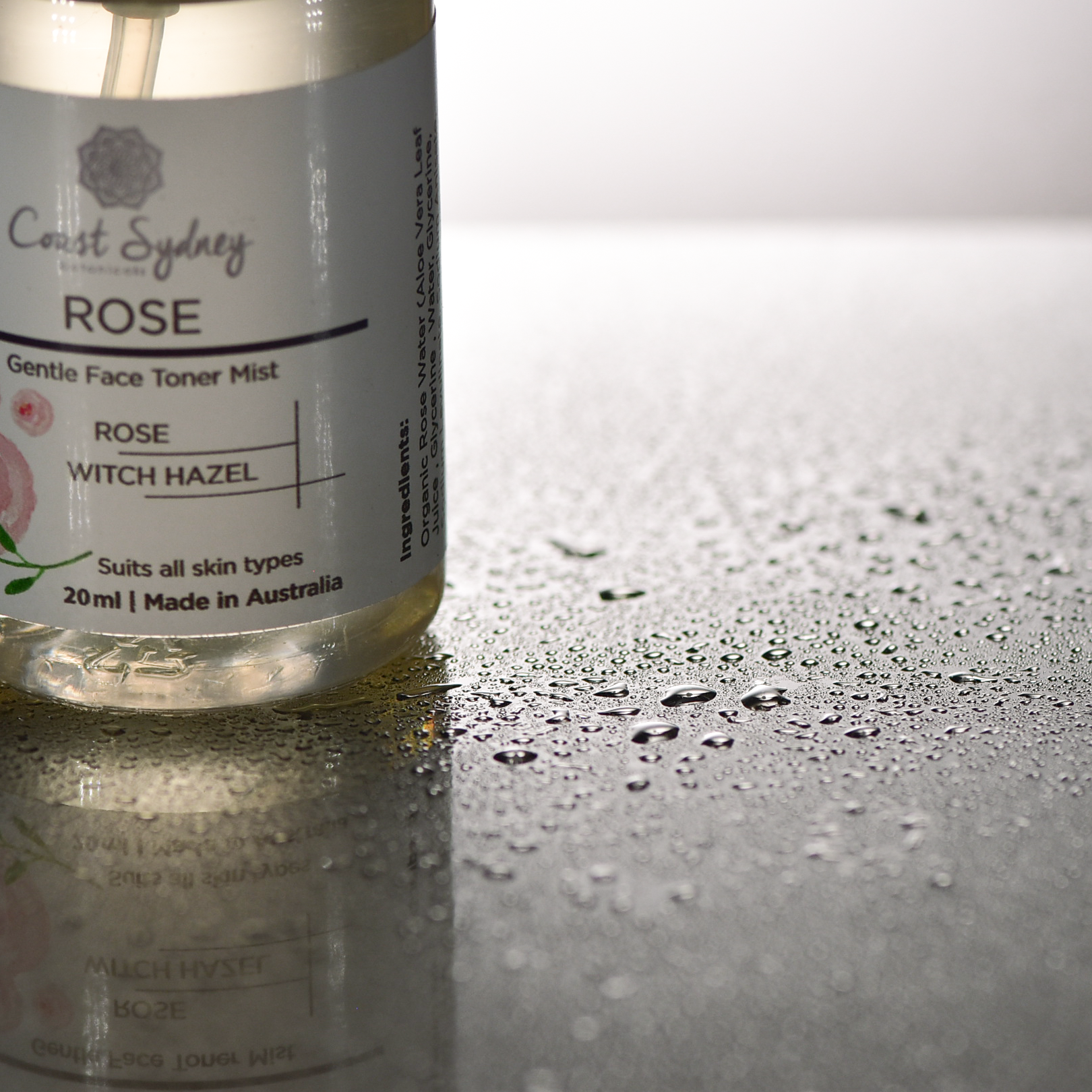  spray bottle of Rose Water Toner alongside suspended mist droplets. sensory experience of using the mist and the hydrating texture it provides to the skin
